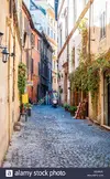 rome-italy-november-18-2018-cozy-narrow-ancient-medieval-old-town-paving-stone-street-with-gr...webp